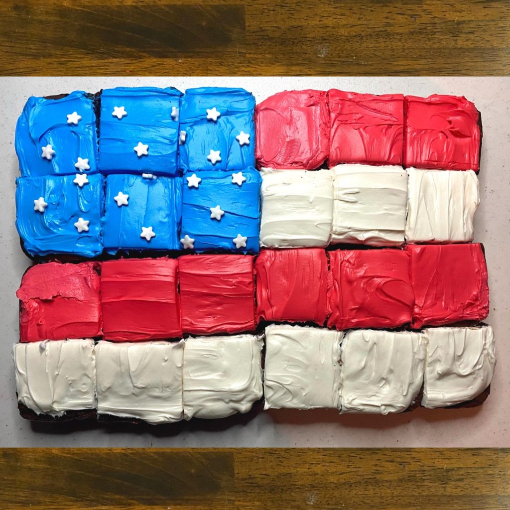 Horizontal image of 24 brownies arranged and decorated to look like an American flag