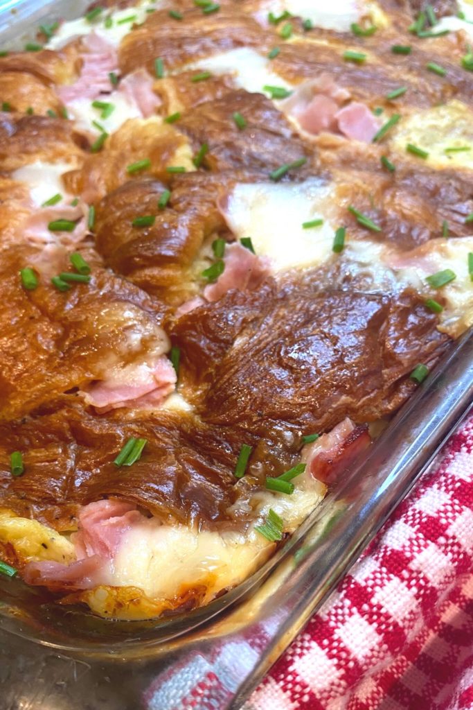 Close up and angled image of a savory overnight croissant casserole recipe