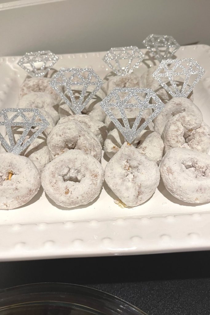 Mini powdered donuts with engagement ring toppers