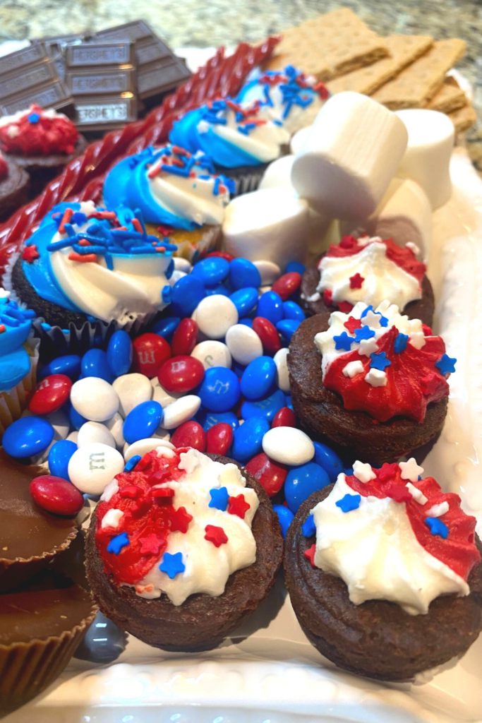 Patriotic brownies, cupcakes, and m&ms on a patriotic tray