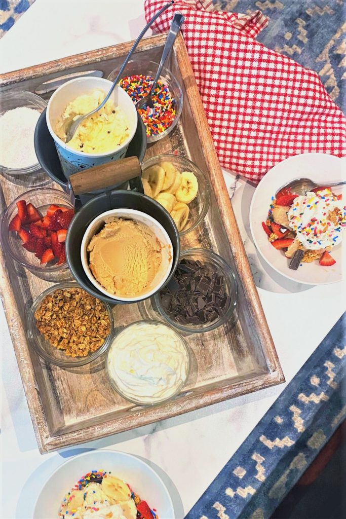 Ice cream charcuterie board on coffee table, with individual ice cream plates