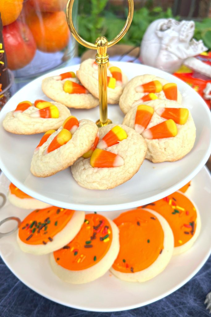 Tiered tray with candy corn cookies and frosted sugar cookies