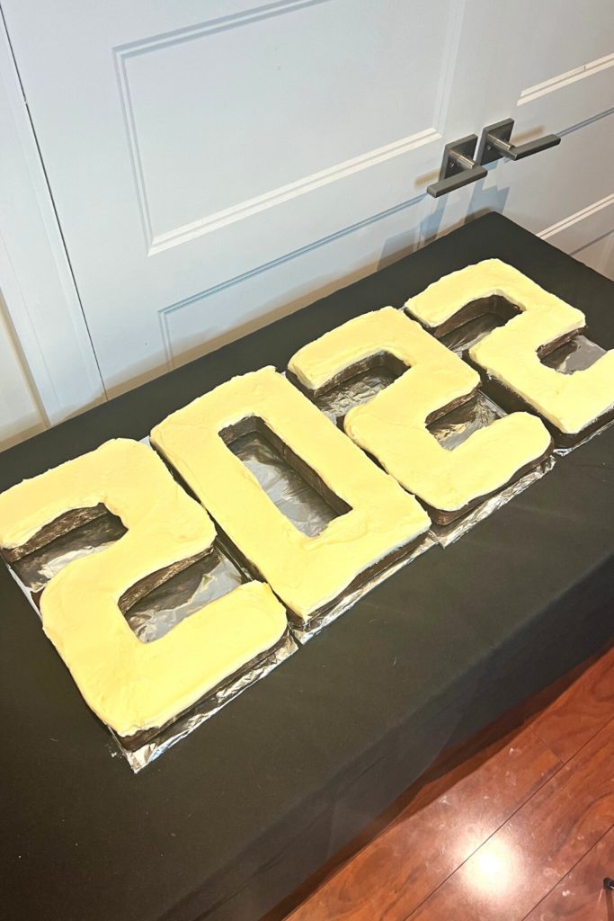 2022 Cake frosted on a table with a black table cloth