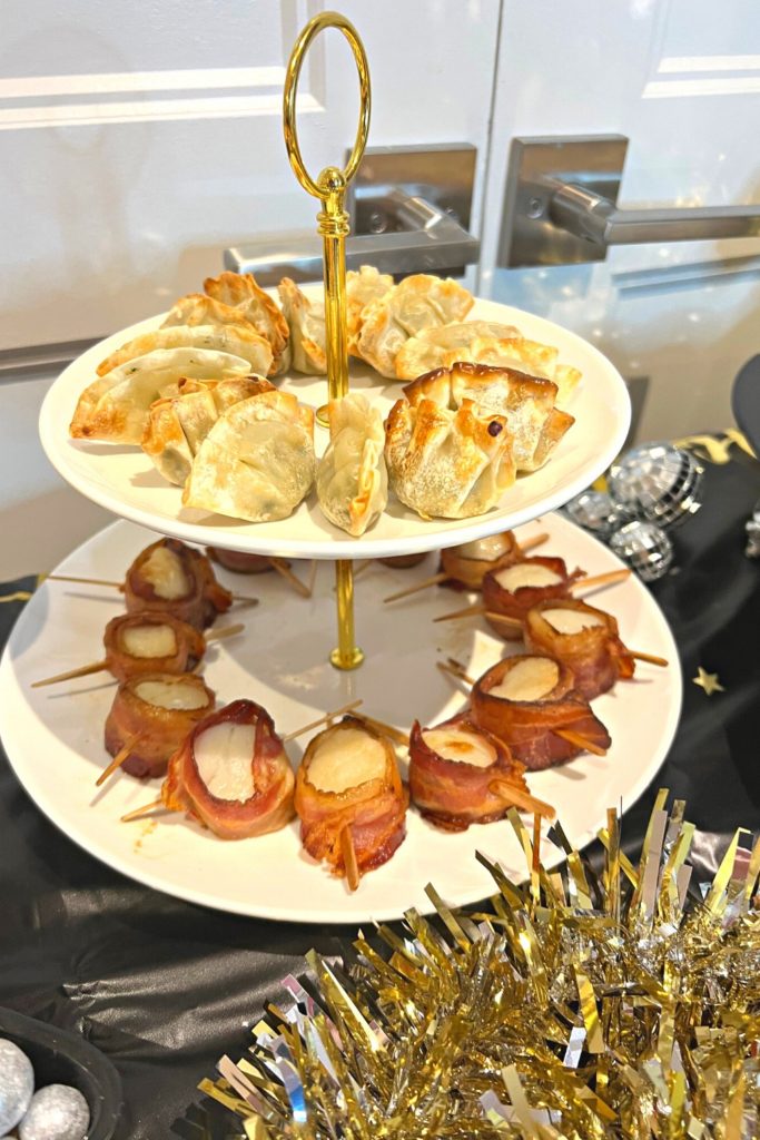 Two tiered tray with wontons and bacon-wrapped scallops